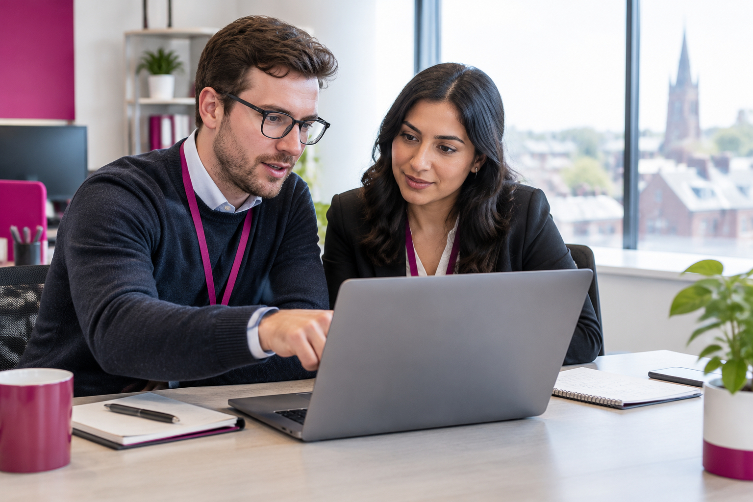 About Smart Cloud IT consultants reviewing a cloud migration plan together in a bright office