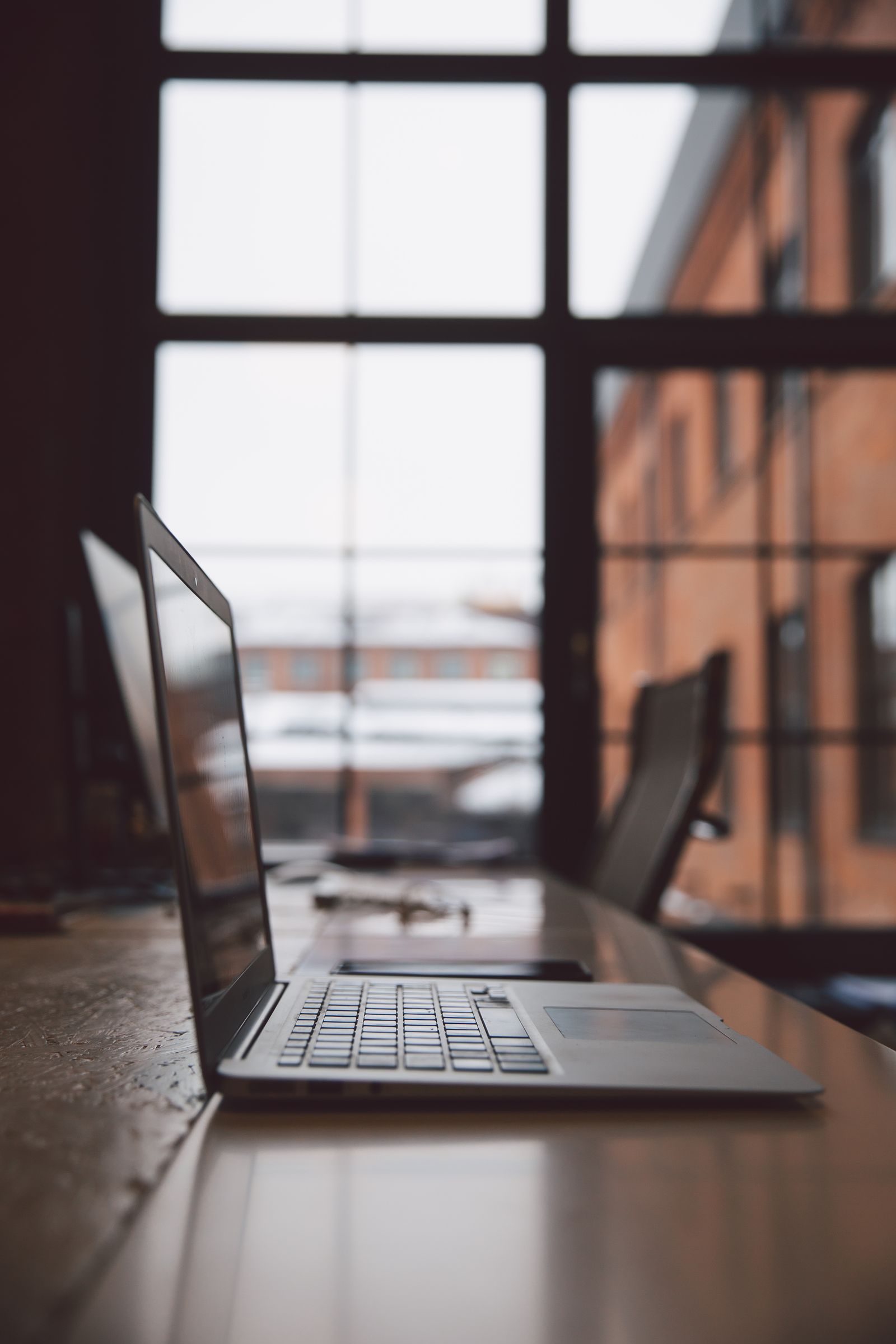 About Smart Cloud Laptop on a desk by the window in a modern office